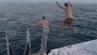 Grant and Chase jumping into the bay